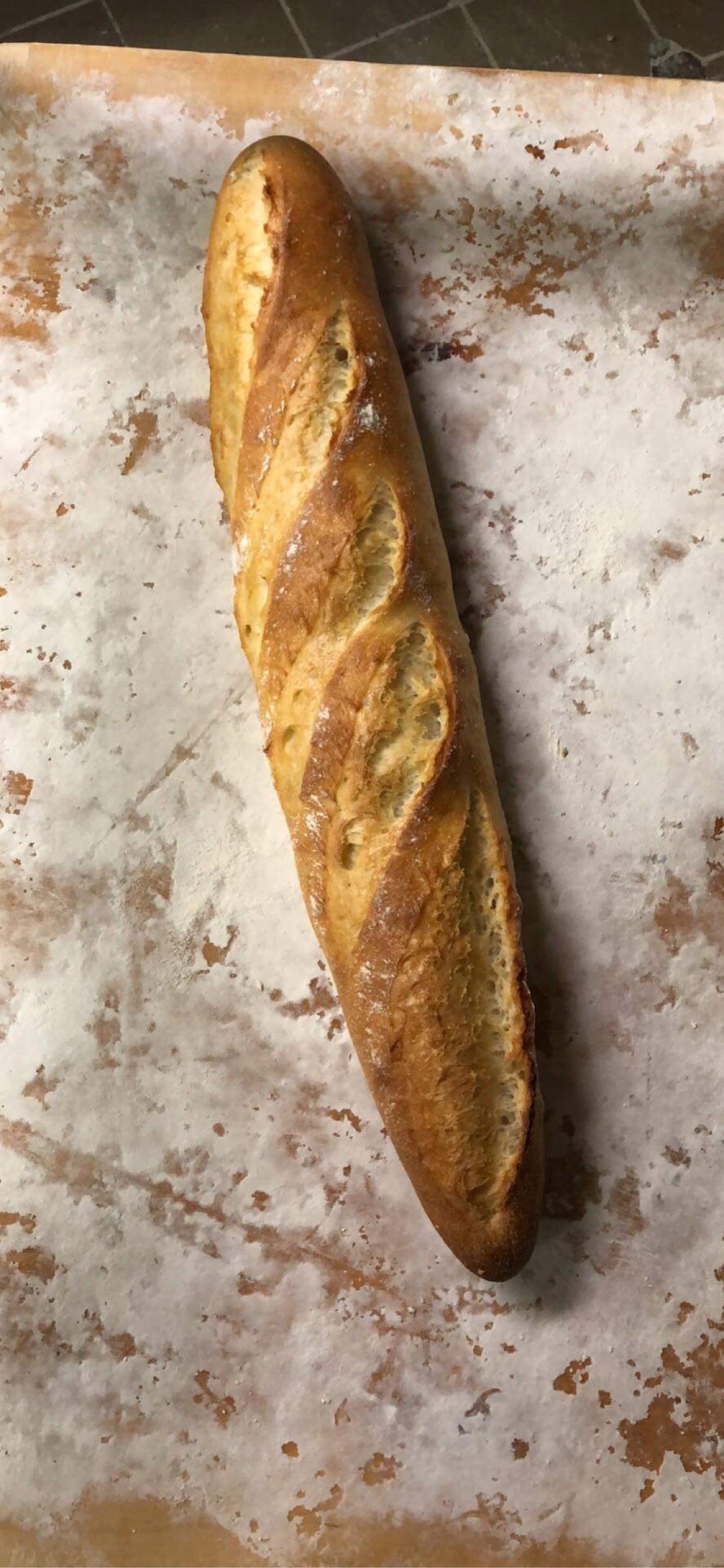 Baguette maison dorée posée sur une plaque de cuisson